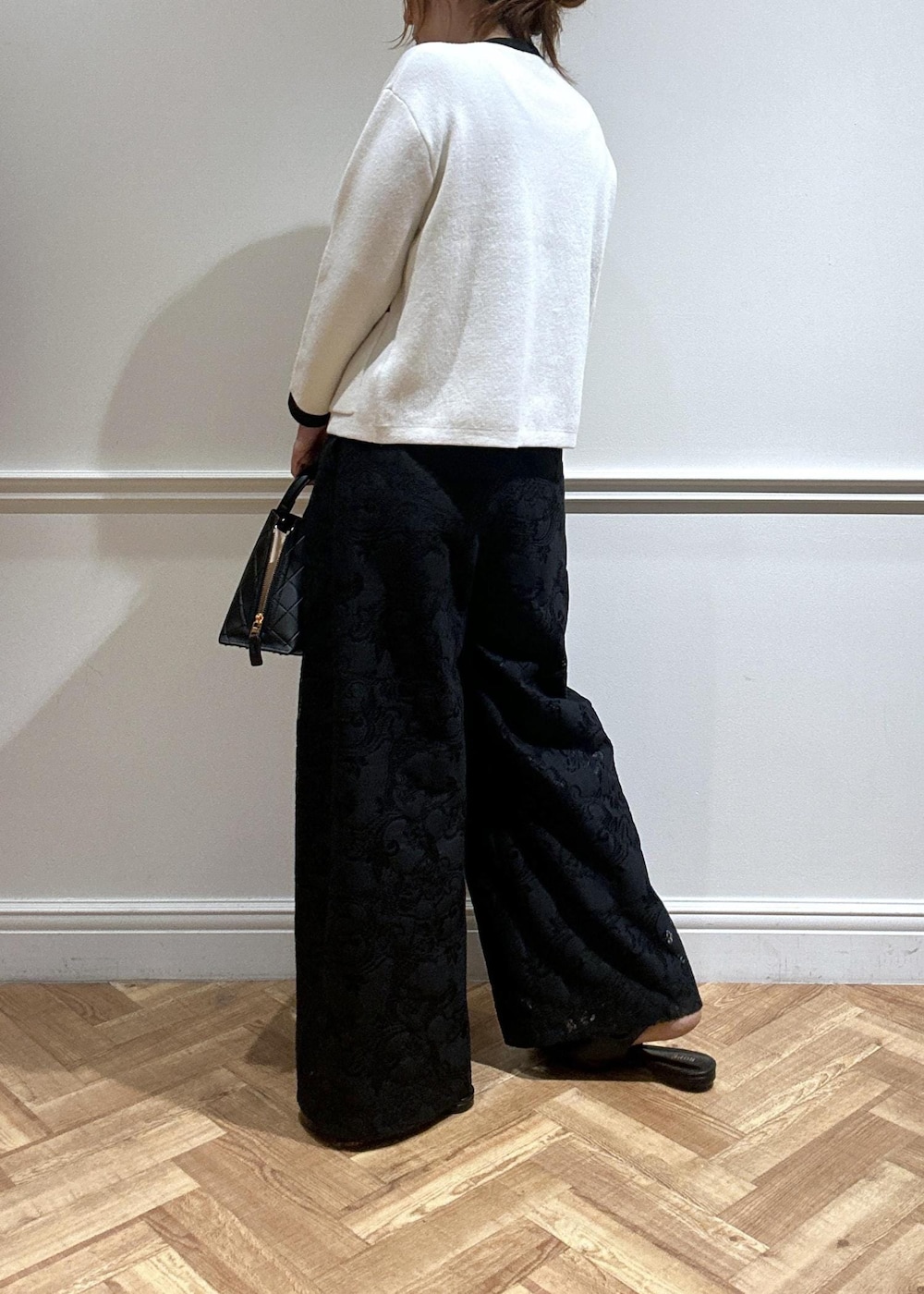 ブラック系のハンドバッグ、ブラック系のパンプス、ブラック系のその他パンツを着用したレディースの秋コーディネートの5枚目の写真