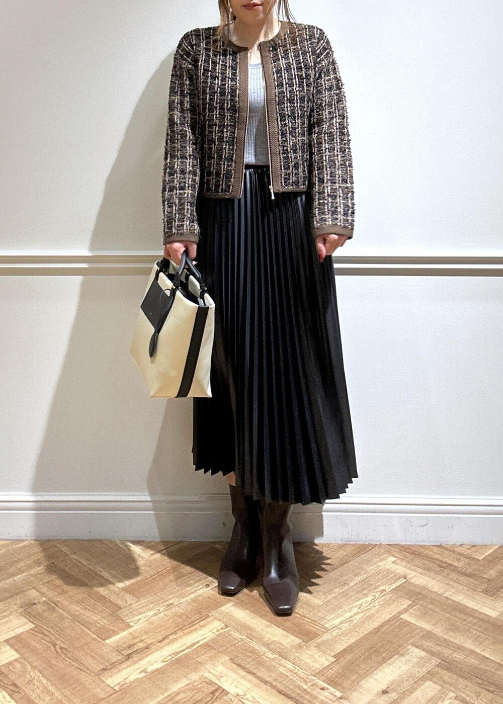 ブラウン系のブーツ、ブラック系のスカート、グレー系のニット/セーターを着用したレディースの秋コーディネートの3枚目の写真