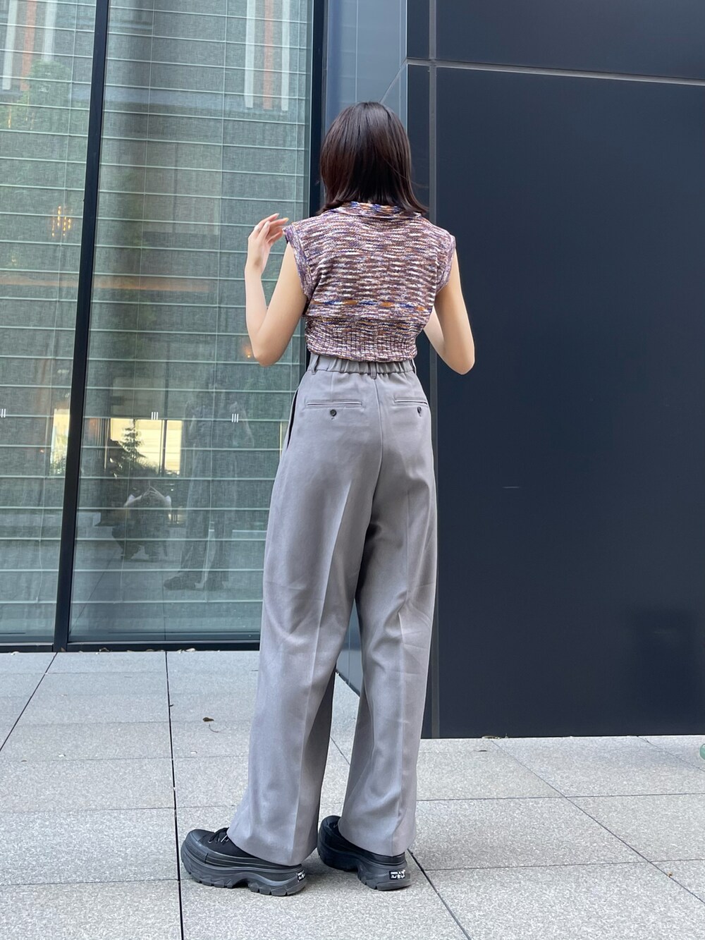 ブルー系のニット/セーター、グレー系のその他パンツを着用したレディースの夏コーディネートの4枚目の写真