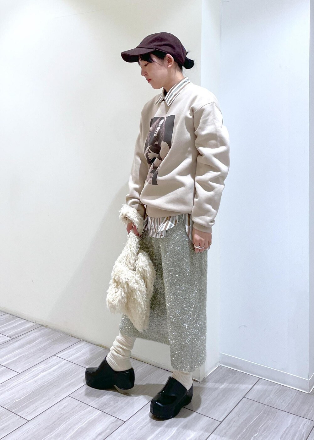 ブラック系のその他シューズ、ホワイト系のハンドバッグ、ホワイト系のソックス/靴下を着用したレディースの冬コーディネートの2枚目の写真