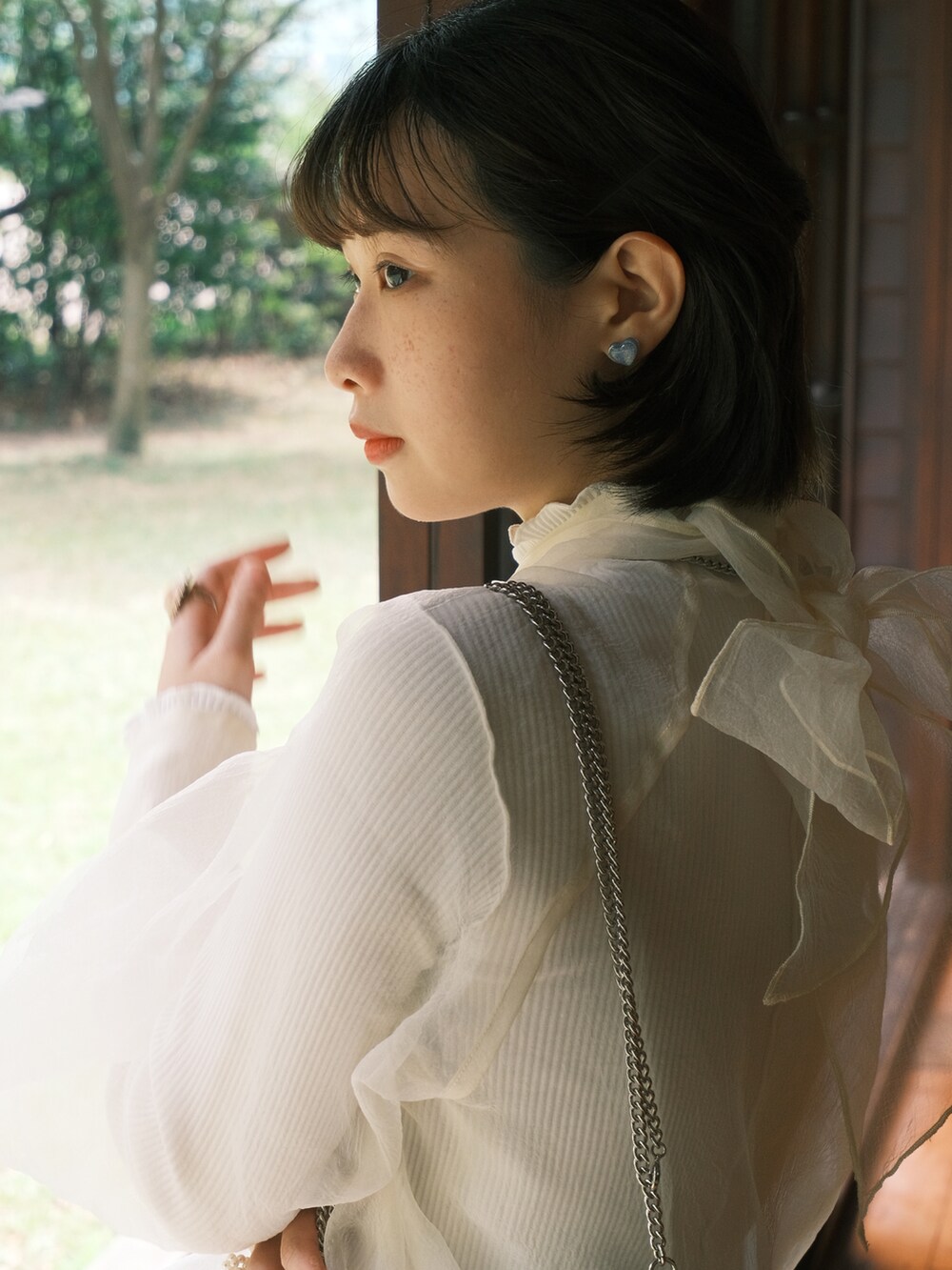 ホワイト系のショルダーバッグ、ブルー系のスカート、ホワイト系のその他トップスを着用したレディースの春コーディネートの3枚目の写真