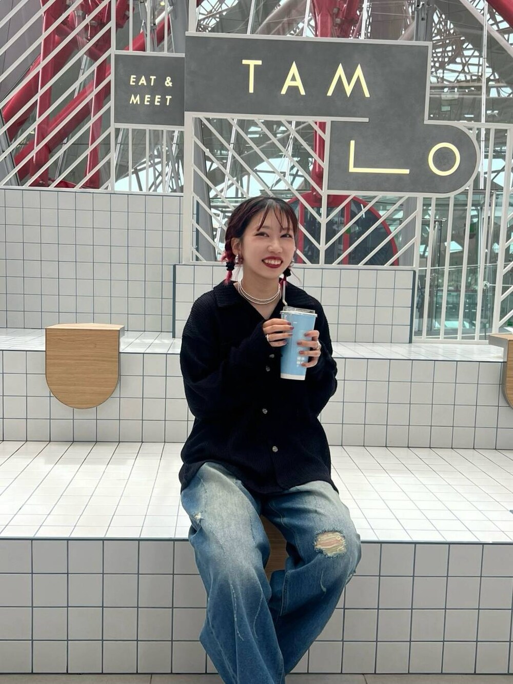 ブルー系のデニムパンツ、ブラック系のシャツ/ブラウスを着用したレディースの秋コーディネートの2枚目の写真