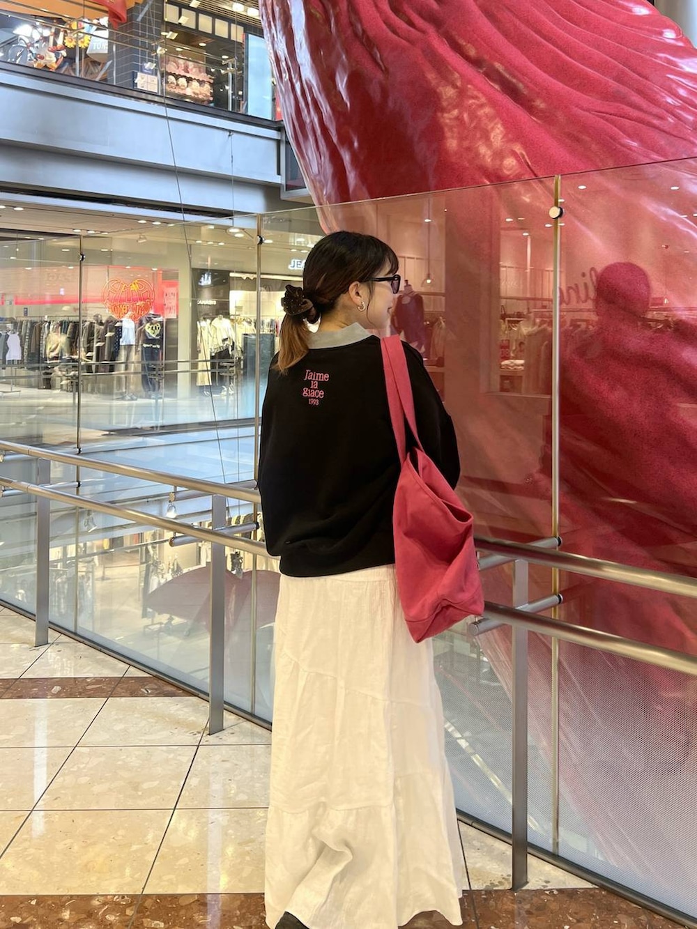 ブラック系のスウェット、ホワイト系のスカート、グレー系のカーディガン/ボレロを着用したレディースの冬コーディネートの3枚目の写真