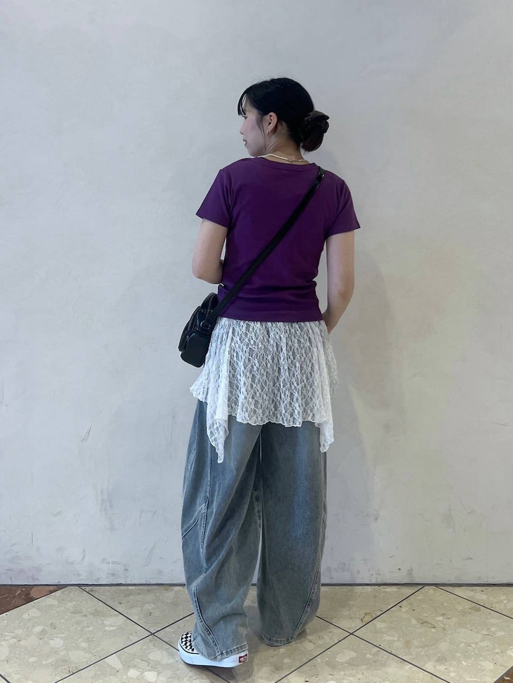 ブルー系のデニムパンツ、ブラック系のショルダーバッグ、ホワイト系のワンピースを着用したレディースの夏コーディネートの2枚目の写真