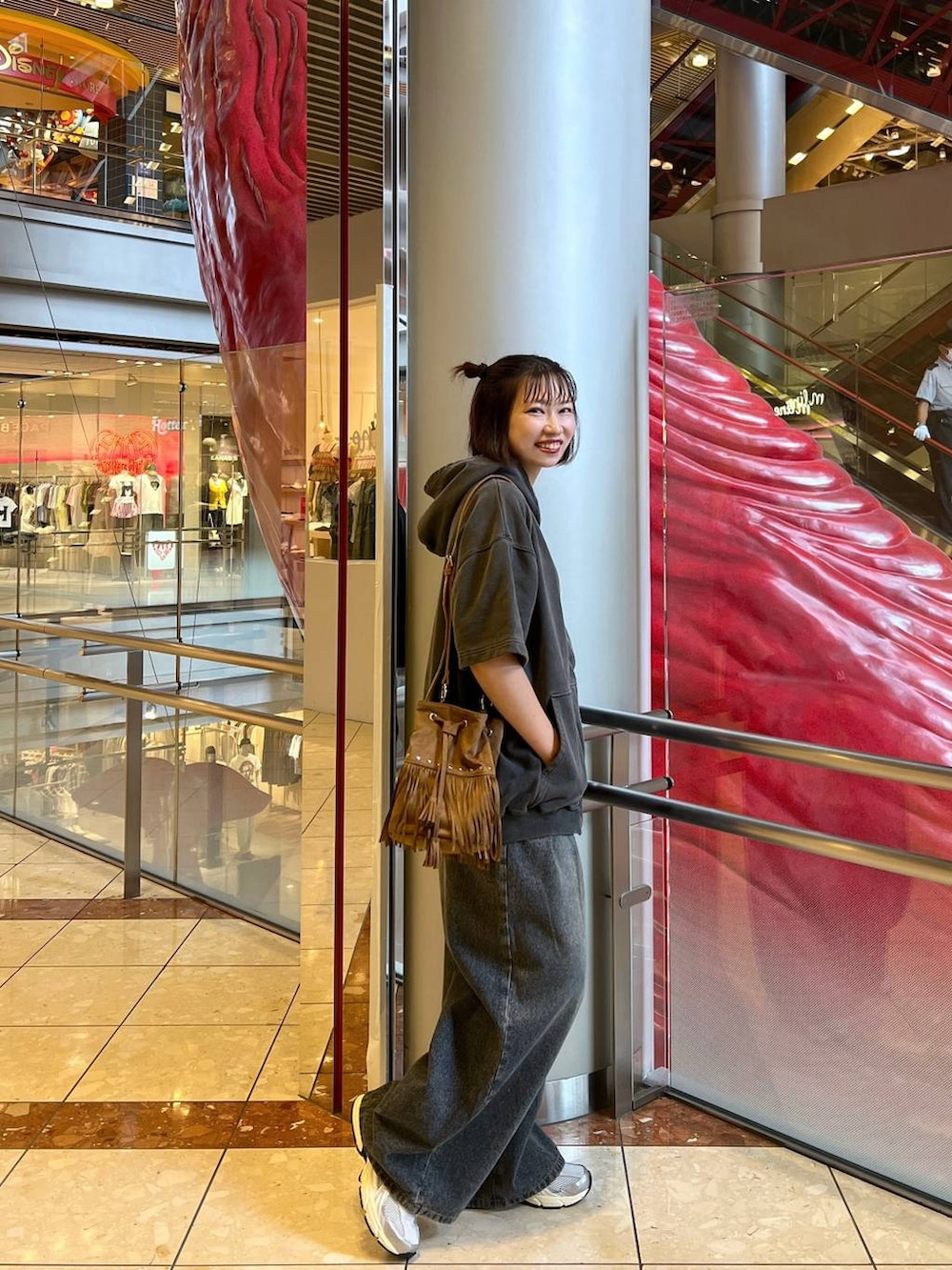ブルー系のデニムパンツ、グレー系のパーカー、ブラック系のデジタル腕時計を着用したレディースの夏コーディネートの4枚目の写真