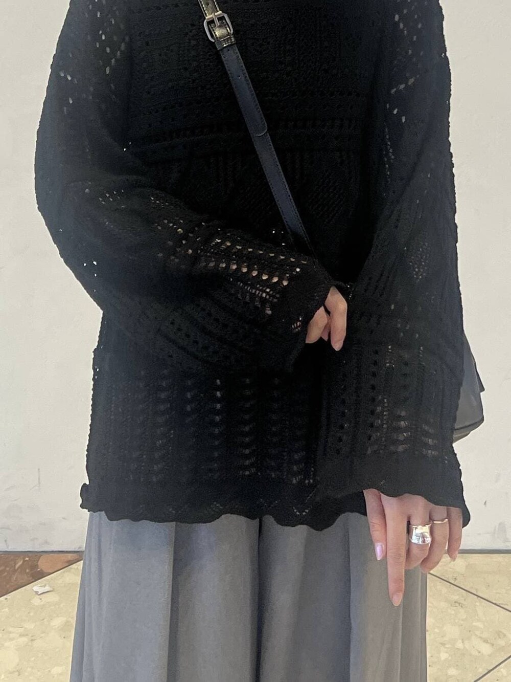 ブラック系のタンクトップ、グレー系のスラックス、ブラック系のショルダーバッグを着用したレディースの春コーディネートの4枚目の写真