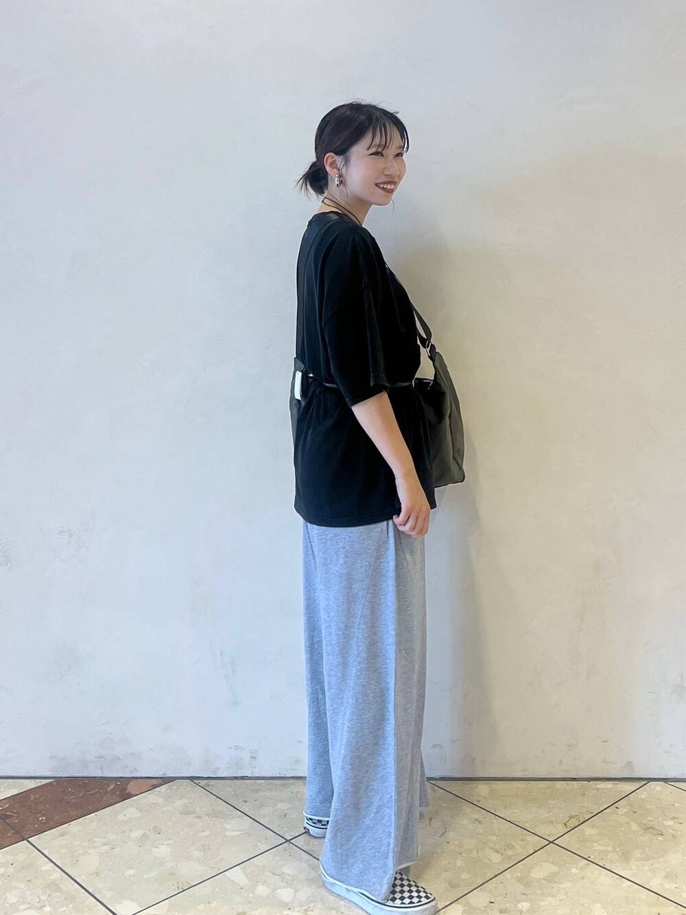 グレー系のショルダーバッグ、グレー系のスウェットパンツ、ブラック系のTシャツ/カットソーを着用したレディースの夏コーディネートの2枚目の写真