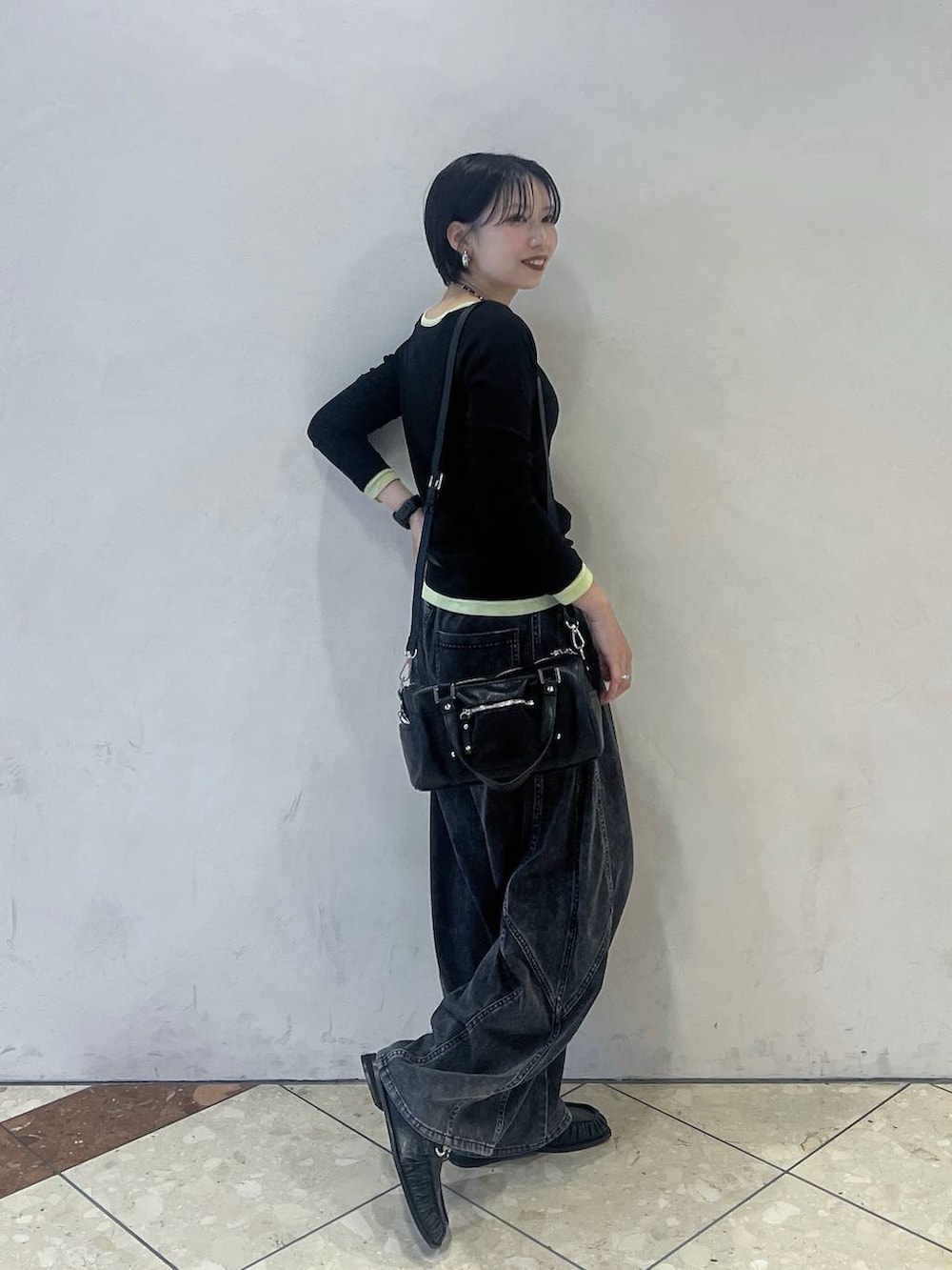 ブラック系のショルダーバッグ、ブラック系のTシャツ/カットソー、ブラック系のデニムパンツを着用したレディースの夏コーディネートの2枚目の写真