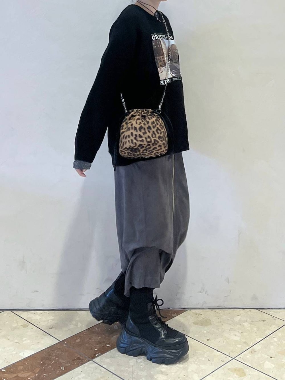 ブラック系のブーツ、その他のハンドバッグ、グレー系のスカートを着用したレディースの冬コーディネートの2枚目の写真