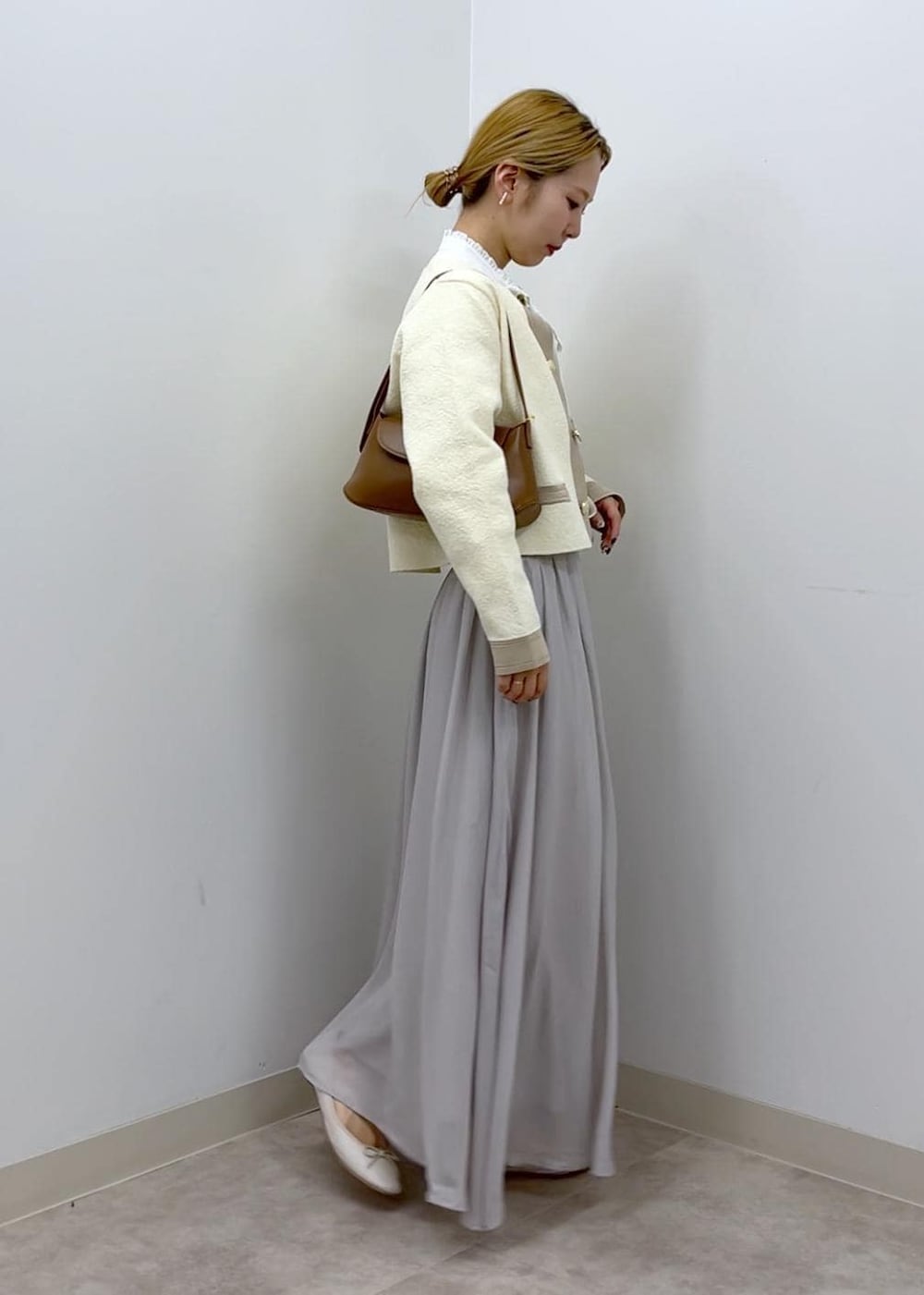 ホワイト系のカーディガン/ボレロ、ホワイト系のシャツ/ブラウス、ブラウン系のショルダーバッグを着用したレディースの秋コーディネートの4枚目の写真