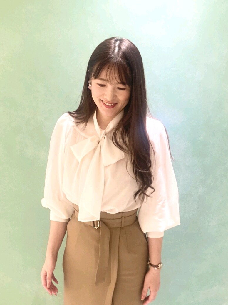 ホワイト系のシャツ/ブラウス、ホワイト系のテーラードジャケット、ブラウン系のスカートを着用したレディースの秋コーディネートの5枚目の写真