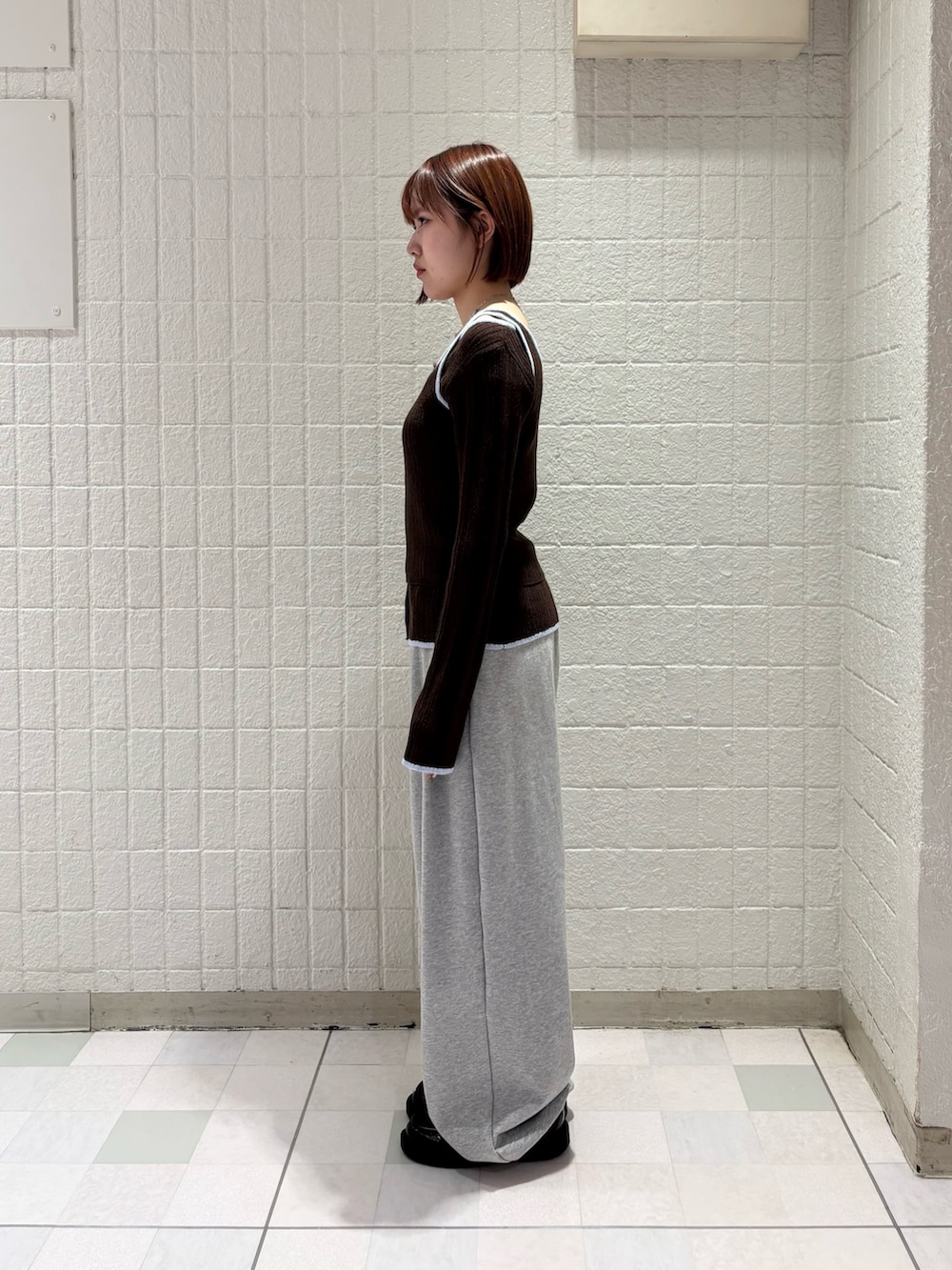 ブラウン系のニット/セーター、グレー系のその他パンツを着用したレディースの冬コーディネートの2枚目の写真