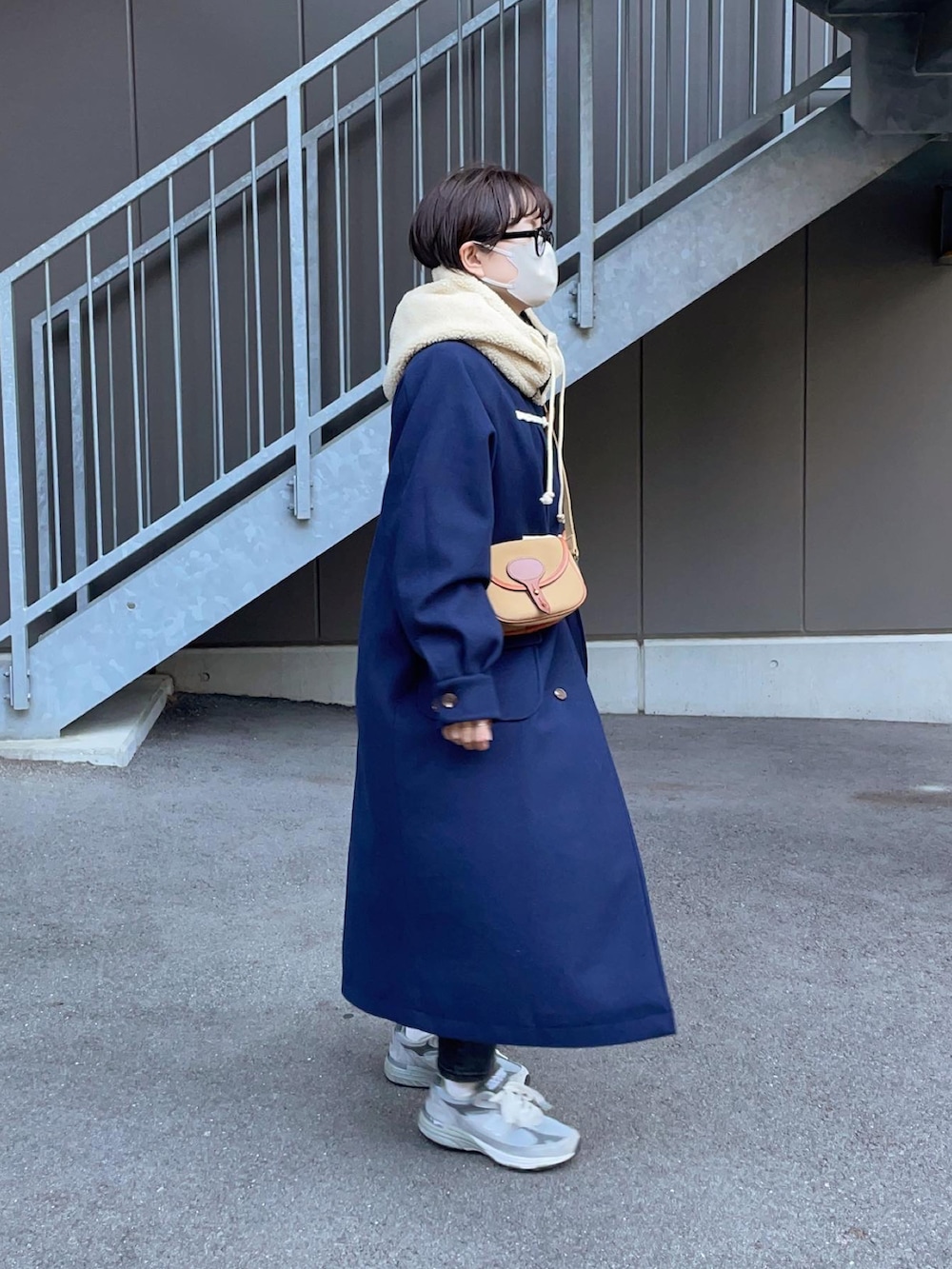 ブルー系のダッフルコート、グレー系のスニーカーを着用したレディースの秋コーディネートの3枚目の写真