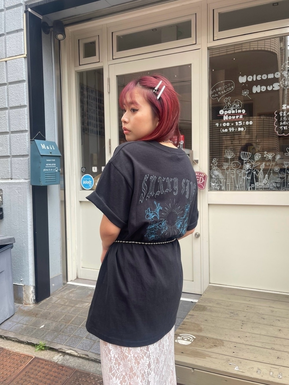 ブラック系のTシャツ/カットソー、ホワイト系のスカート、ブラック系のブーツを着用したレディースの春コーディネートの2枚目の写真