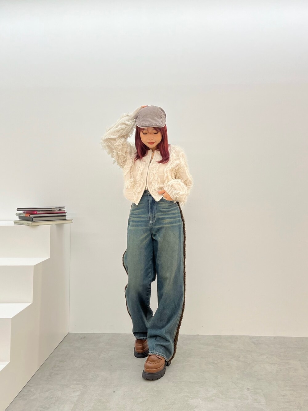 ホワイト系のニット/セーター、ブルー系のデニムパンツ、ブラウン系のローファーを着用したレディースの夏コーディネートの2枚目の写真