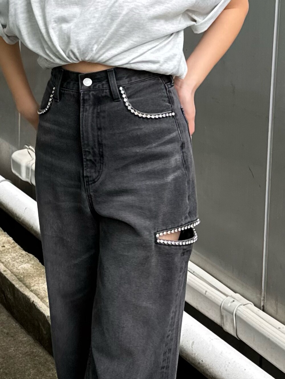 グレー系のTシャツ/カットソー、ブラック系のデニムパンツ、ホワイト系のサンダルを着用したレディースの春コーディネートの3枚目の写真