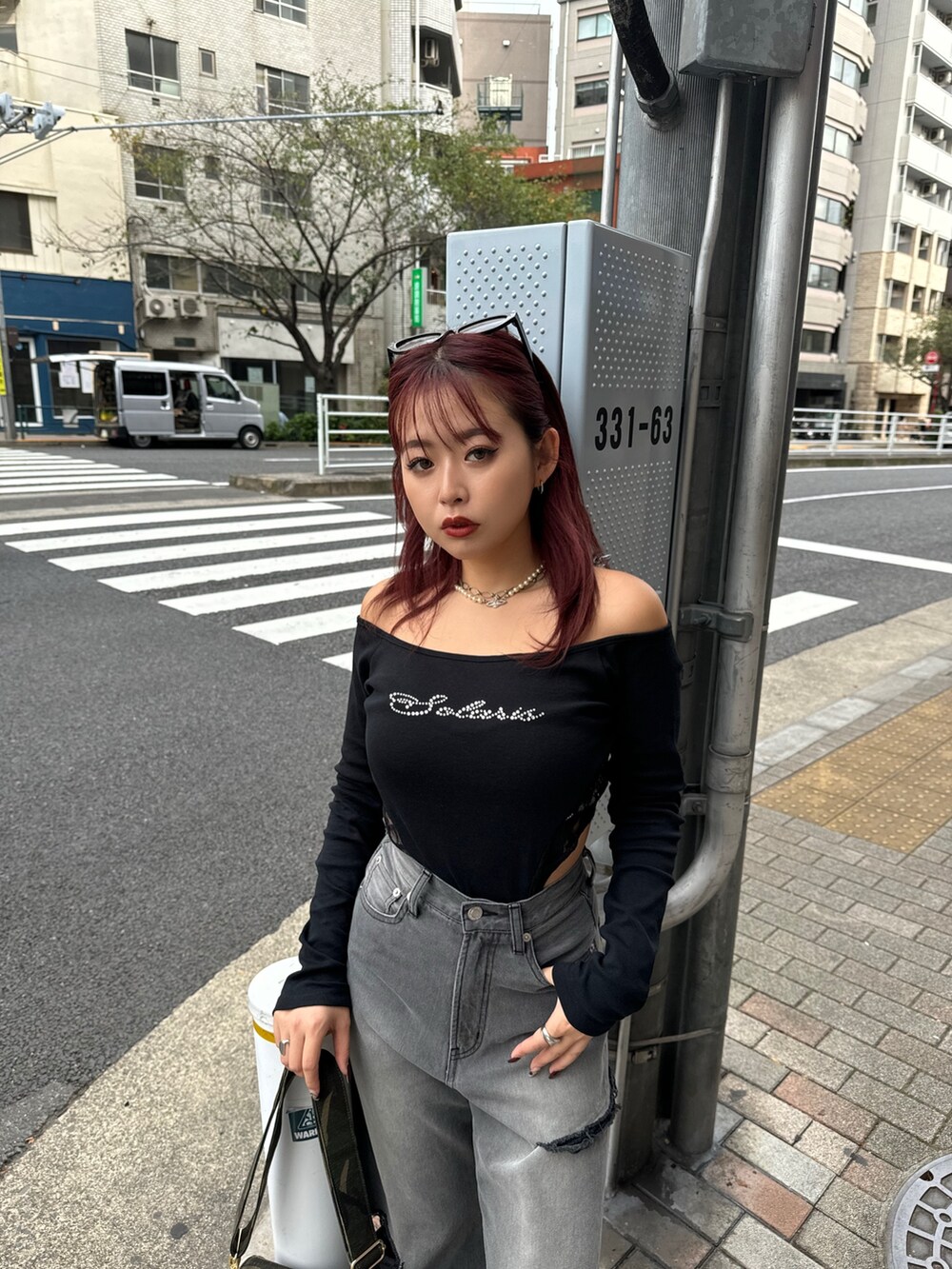 ブラック系のTシャツ/カットソー、グリーン系のショルダーバッグ、ブラック系のデニムパンツを着用したレディースの秋コーディネートの3枚目の写真