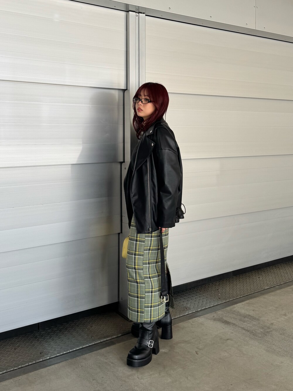 イエロー系のシャツ/ブラウス、ブラック系のスウェット、ブラック系のライダースジャケットを着用したレディースの冬コーディネートの3枚目の写真