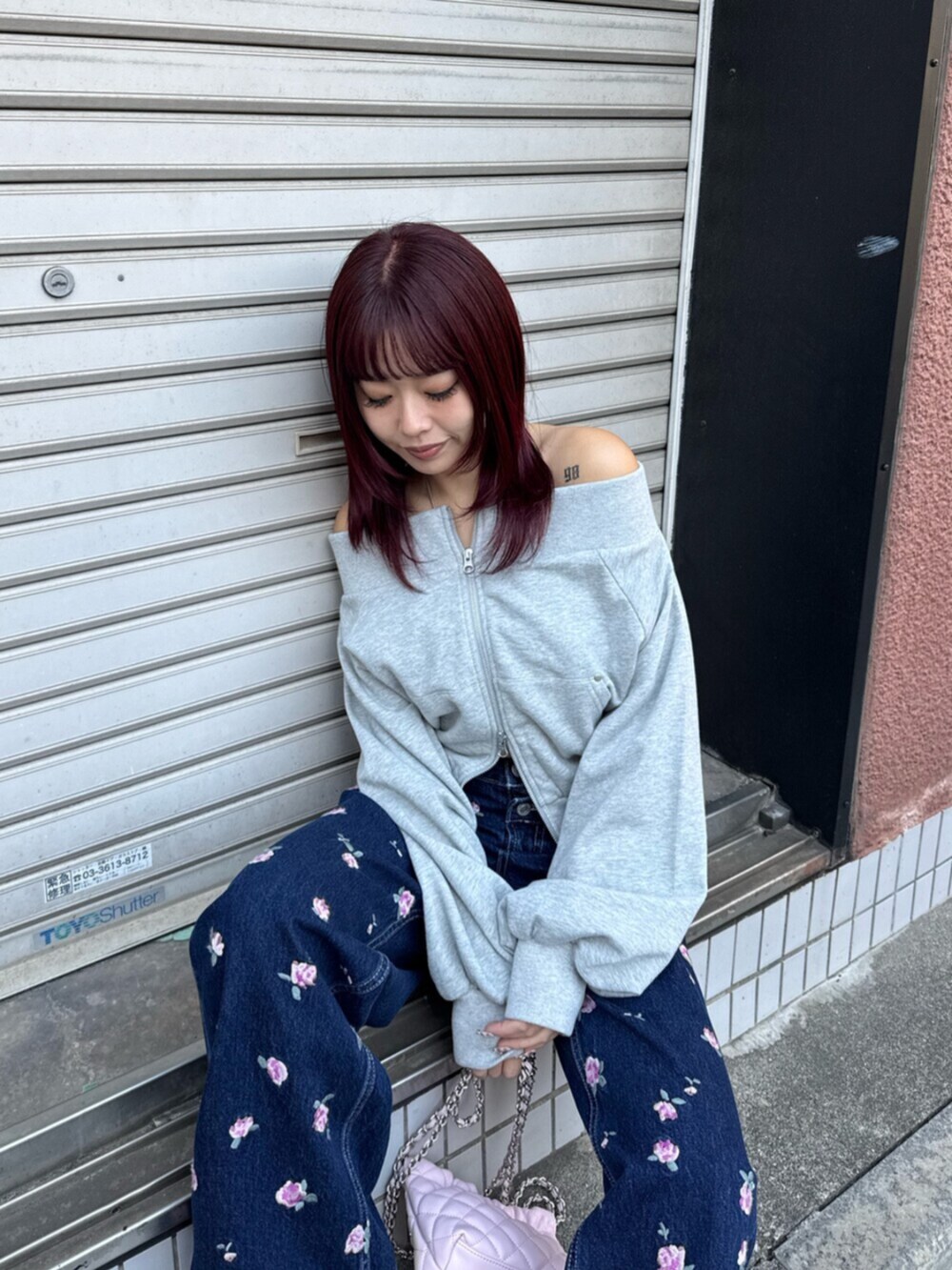 シルバー系のパンプス、グレー系のスウェット、ピンク系のショルダーバッグを着用したレディースの冬コーディネートの4枚目の写真