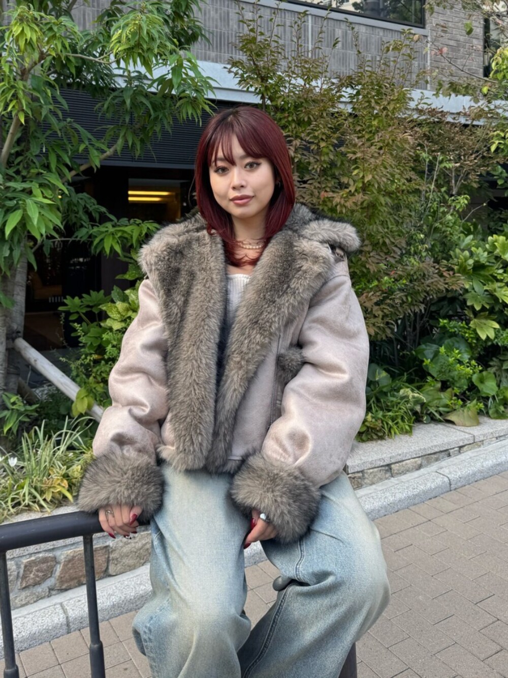 ブルー系のデニムパンツ、ホワイト系のニット/セーター、ベージュ系のブルゾンを着用したレディースの秋コーディネートの4枚目の写真