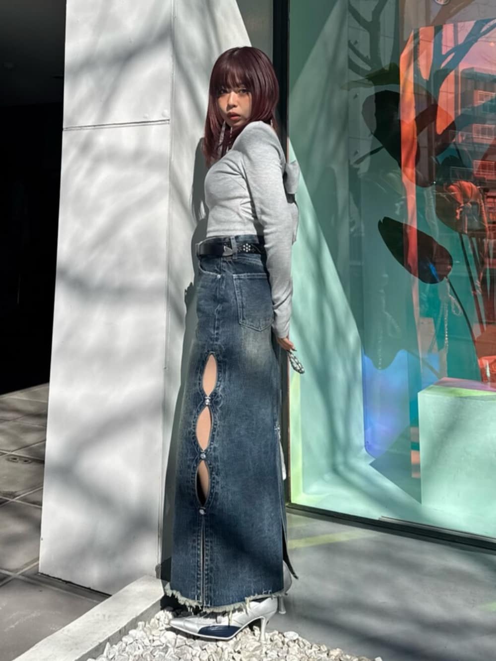 シルバー系のパンプス、ブルー系のデニムスカート、グレー系のTシャツ/カットソーを着用したレディースの春コーディネートの2枚目の写真