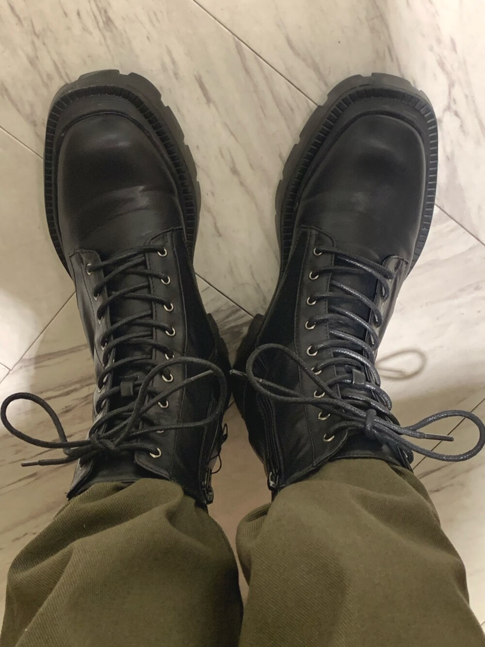 ホワイト系のカーディガン/ボレロ、グリーン系のデニムパンツ、ブラック系のブーツを着用したレディースの冬コーディネートの5枚目の写真