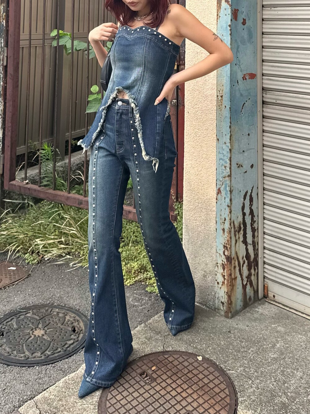 ブルー系のキャミソール、ブルー系のデニムパンツ、ブルー系のパンプスを着用したレディースの夏コーディネートの2枚目の写真