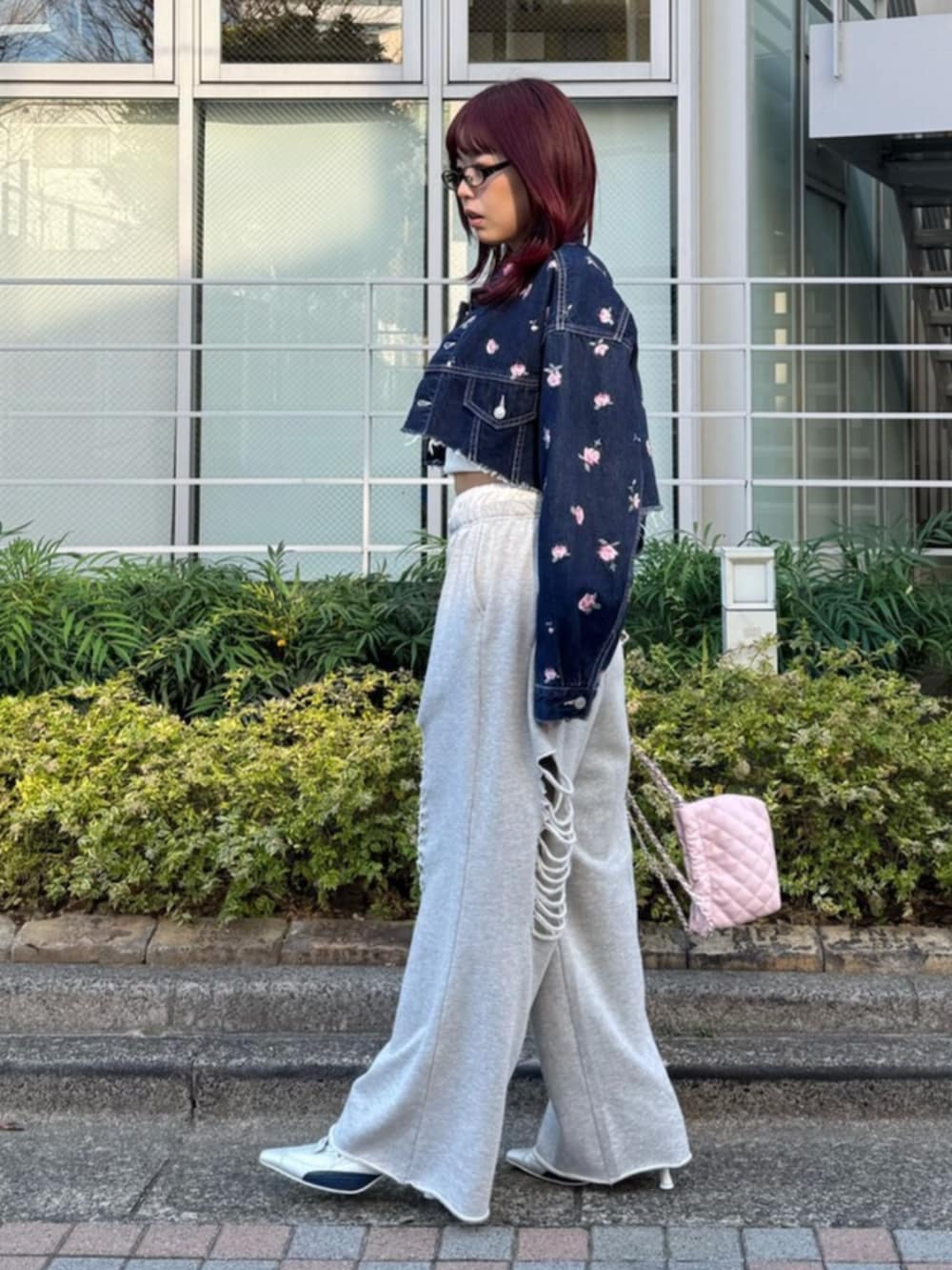 シルバー系のパンプス、グレー系のスウェットパンツ、ピンク系のショルダーバッグを着用したレディースの冬コーディネートの3枚目の写真