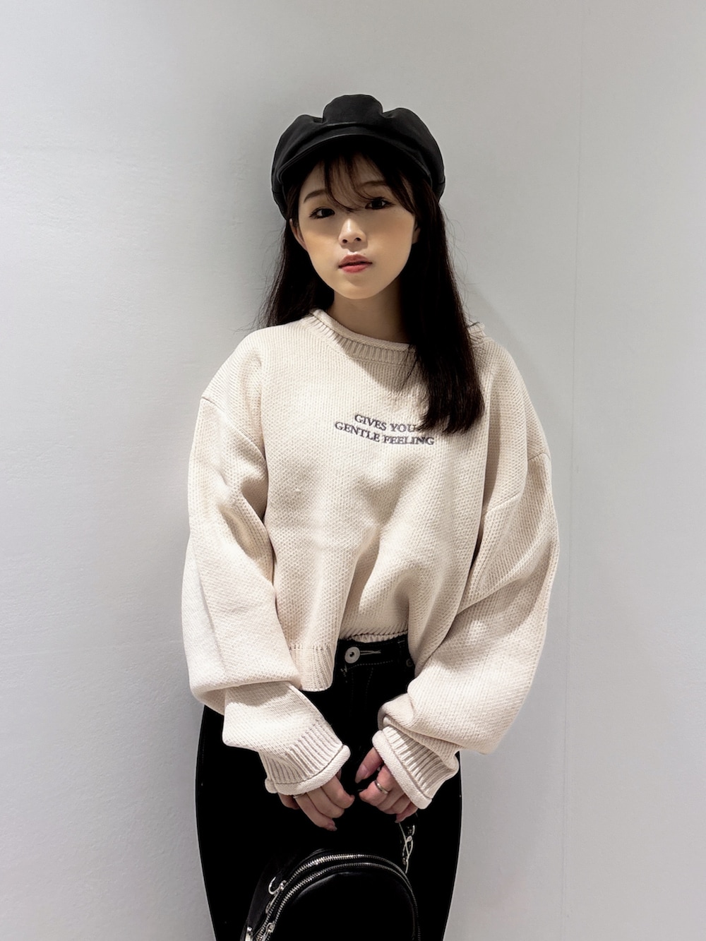 ピンク系のニット/セーター、ブラック系のブーツ、ブラック系のバックパック/リュックを着用したレディースの秋コーディネートの4枚目の写真