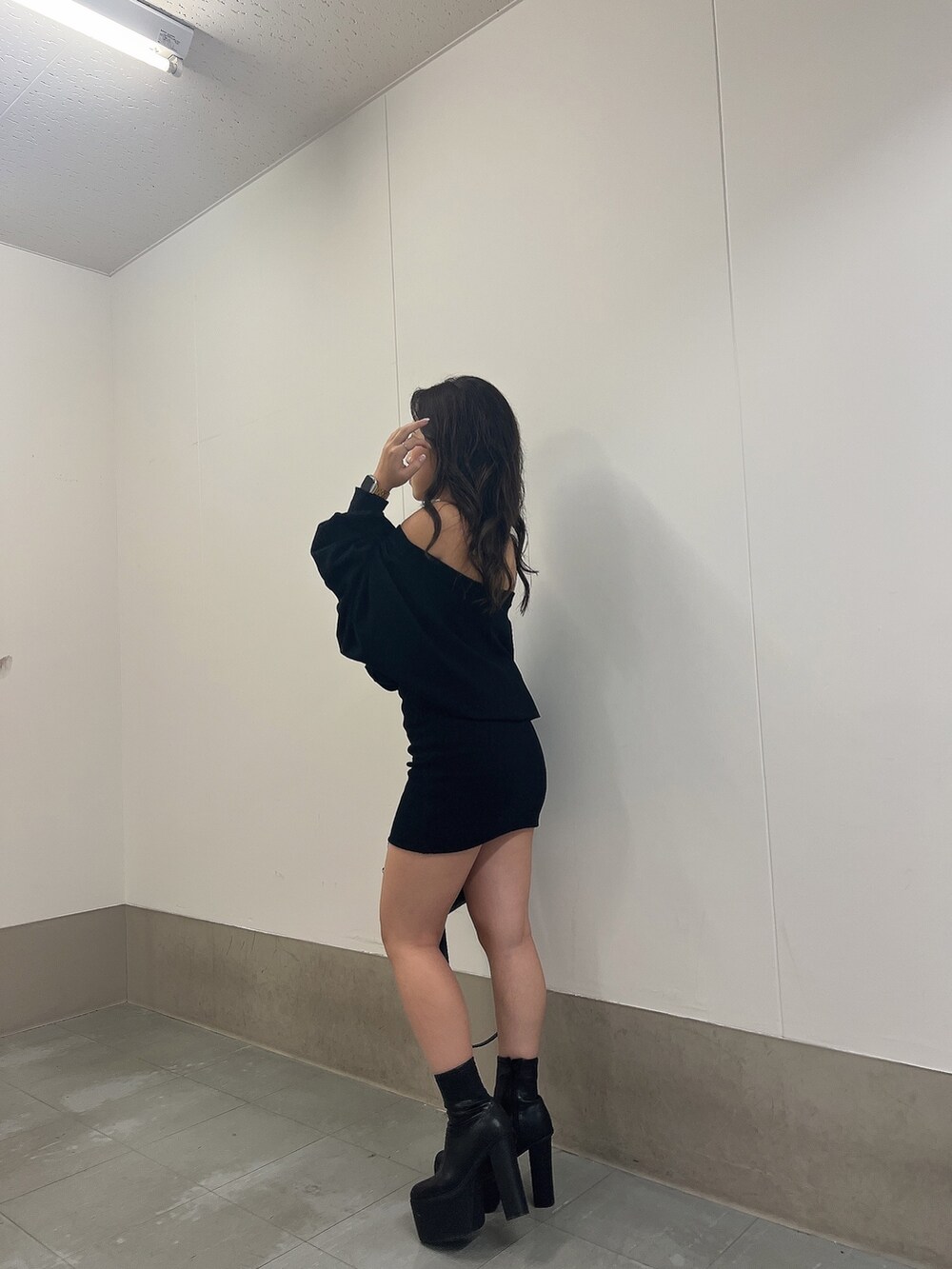 ブラック系のワンピース、ブラック系のブーツ、ブラック系のバックパック/リュックを着用したレディースの秋コーディネートの3枚目の写真