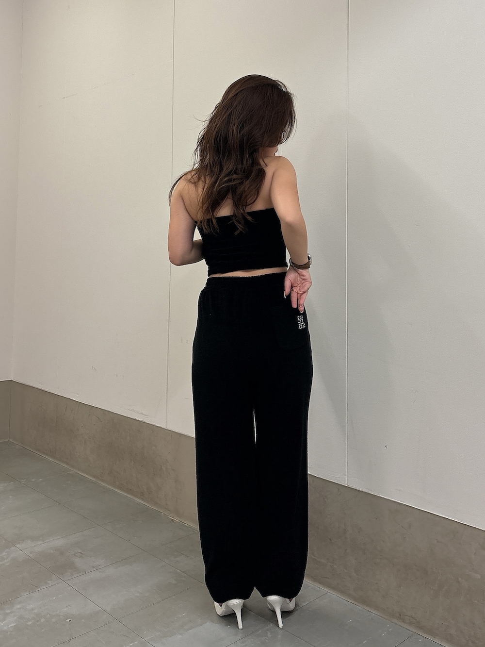 ブラック系のチューブトップ、ブラック系のその他パンツ、ホワイト系のパンプスを着用したレディースの春コーディネートの3枚目の写真