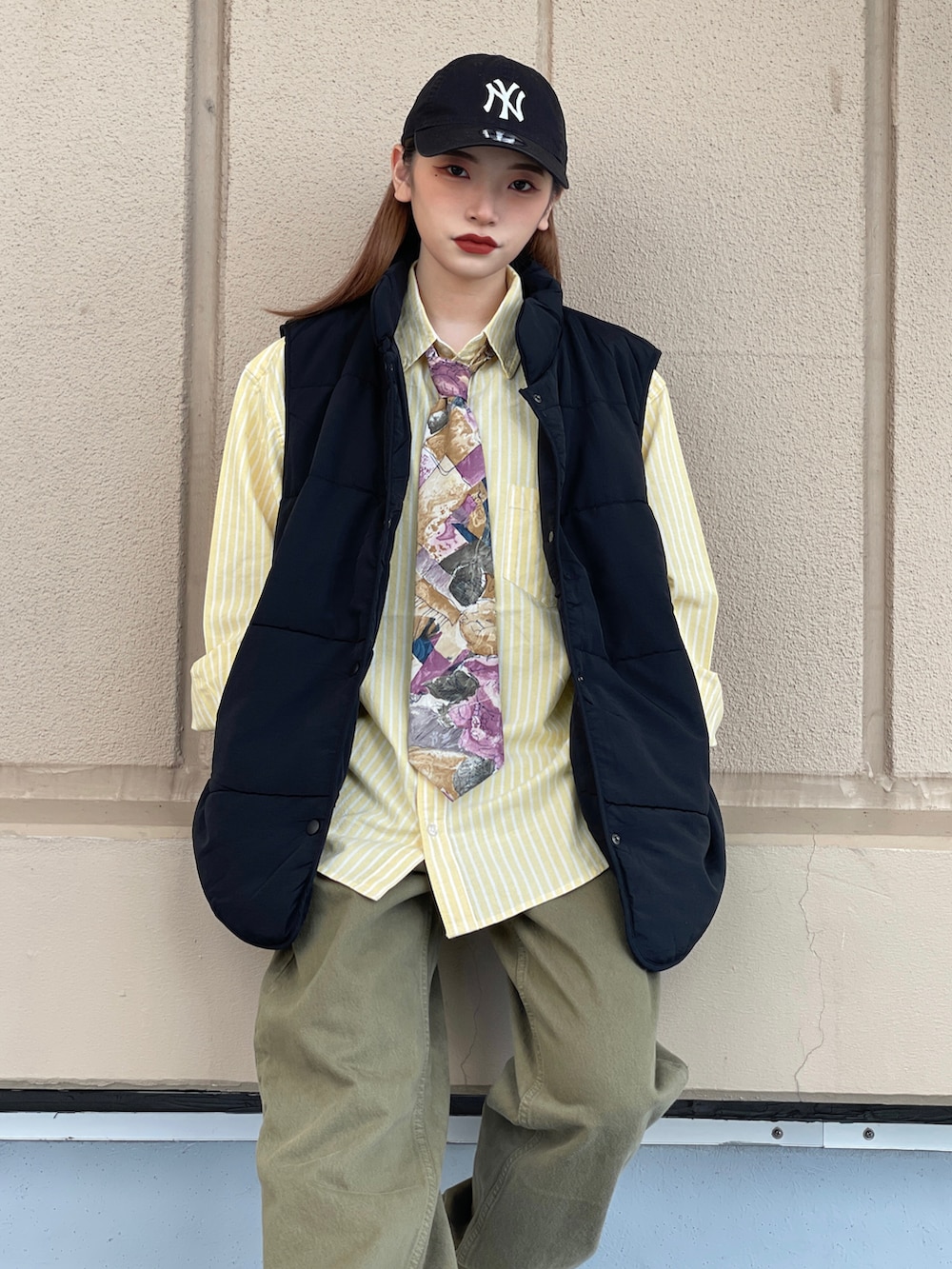 グリーン系のデニムパンツ、ベージュ系のスニーカー、その他のネクタイを着用したレディースの秋コーディネートの2枚目の写真