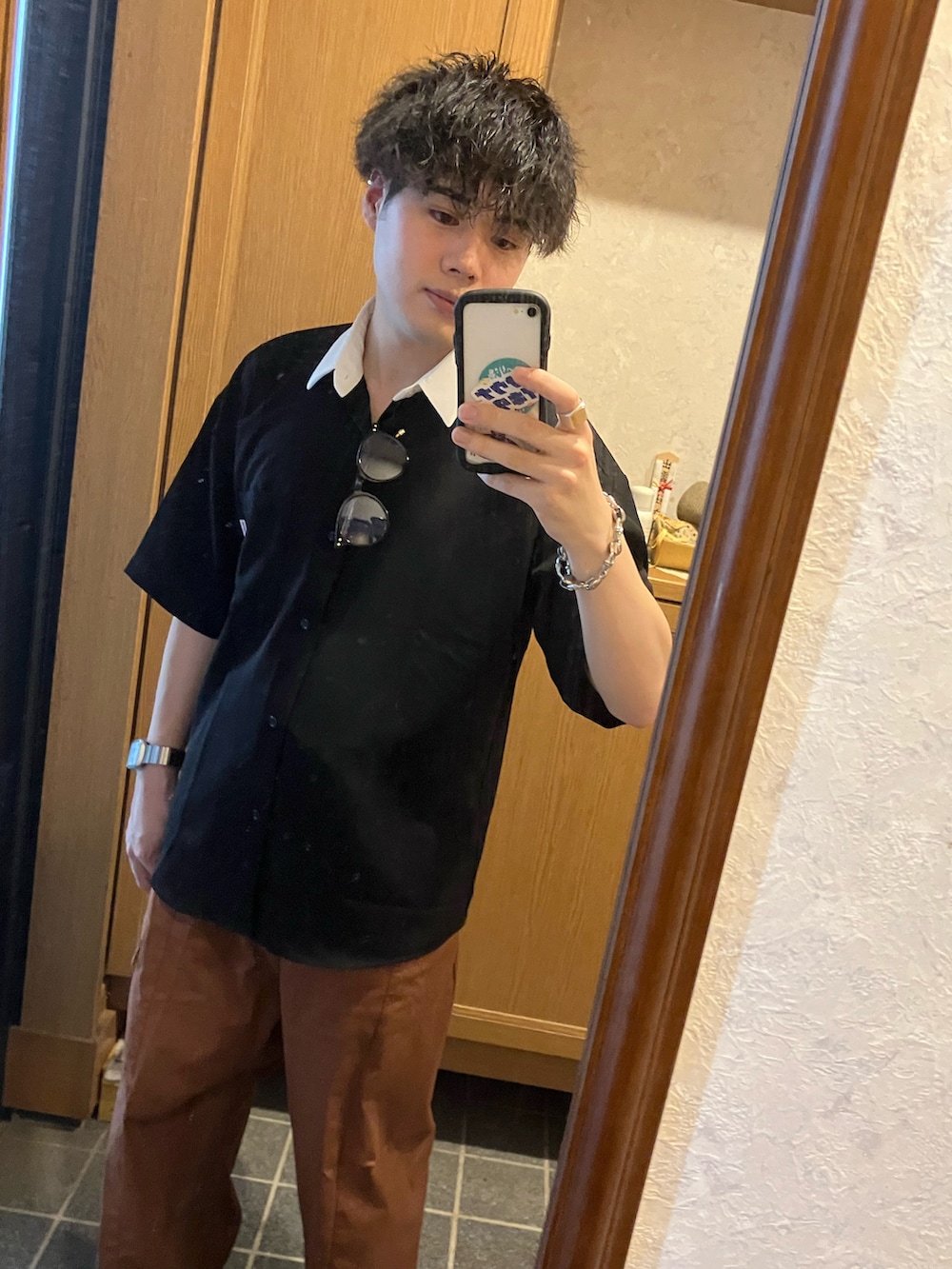 ブラック系のシャツ/ブラウス、ブラウン系のカーゴパンツ、シルバー系のブレスレットを着用したメンズの春コーディネートの2枚目の写真