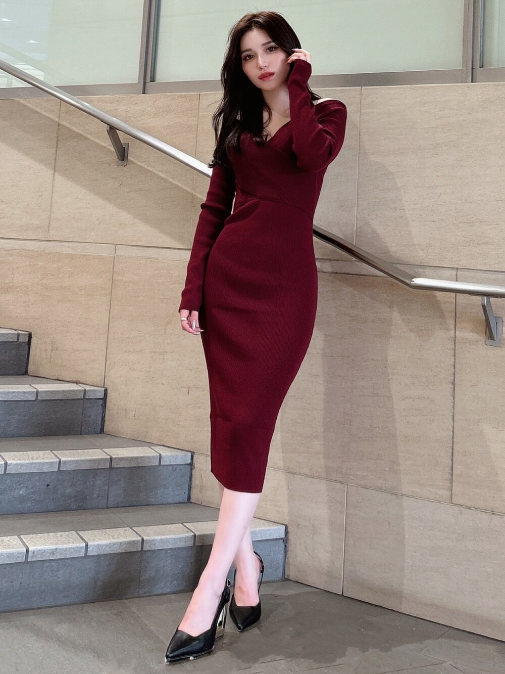 レッド系のワンピース、ブラック系のサンダルを着用したレディースの秋コーディネートの2枚目の写真