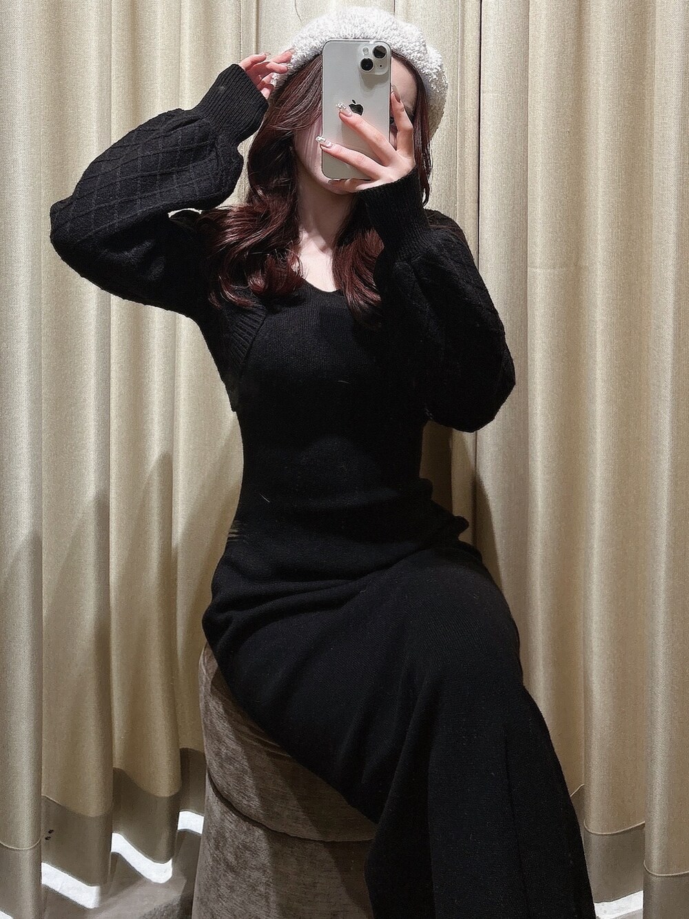 ブラック系のワンピース、ブラック系のハンドバッグ、ブラック系のブーツを着用したレディースの冬コーディネートの2枚目の写真