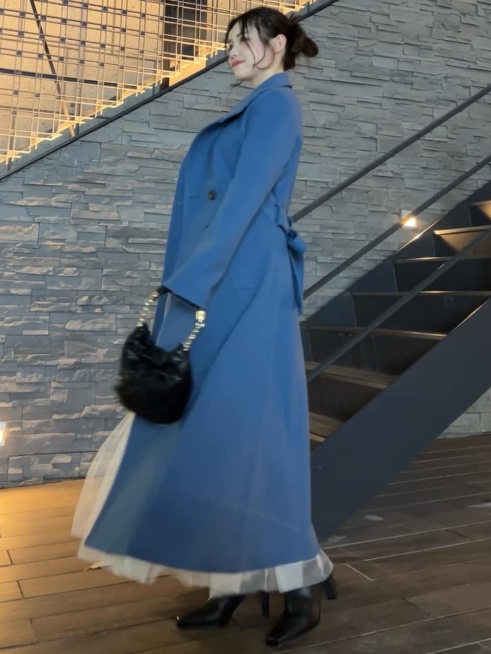 ブルー系のその他アウター、ブラック系のハンドバッグ、ブラック系のブーツを着用したレディースの秋コーディネートの5枚目の写真