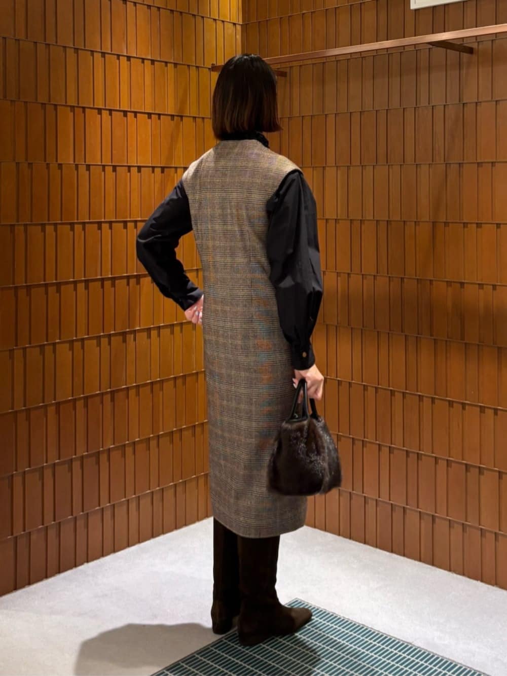 ブラウン系のブーツ、ブラウン系のピーコート、ブラウン系のワンピースを着用したレディースの秋コーディネートの4枚目の写真