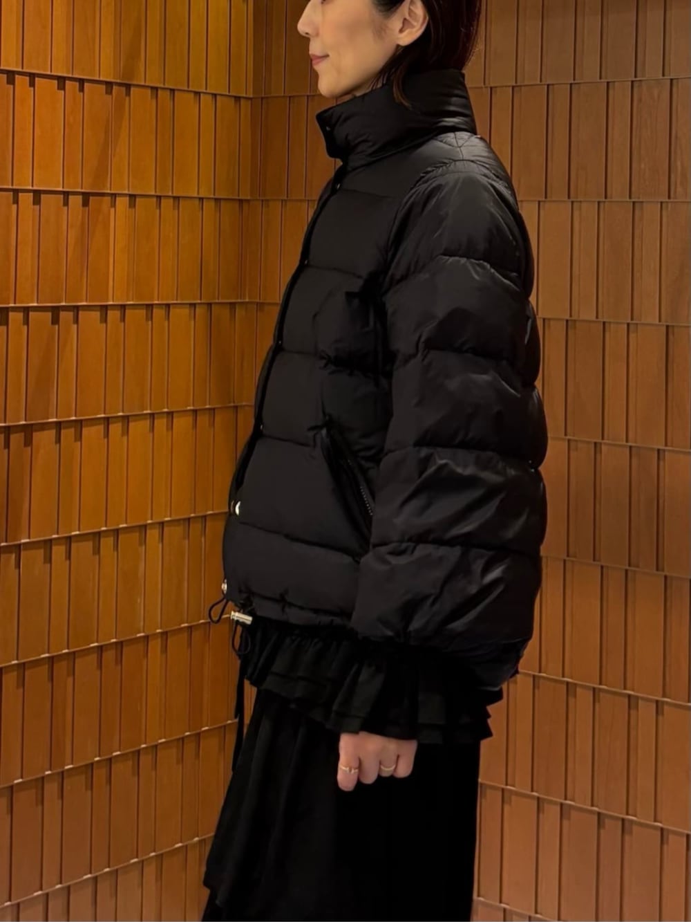 ブラック系のブーツ、ブラック系のダウンジャケット/コート、ブラック系のシャツ/ブラウスを着用したレディースの秋コーディネートの5枚目の写真