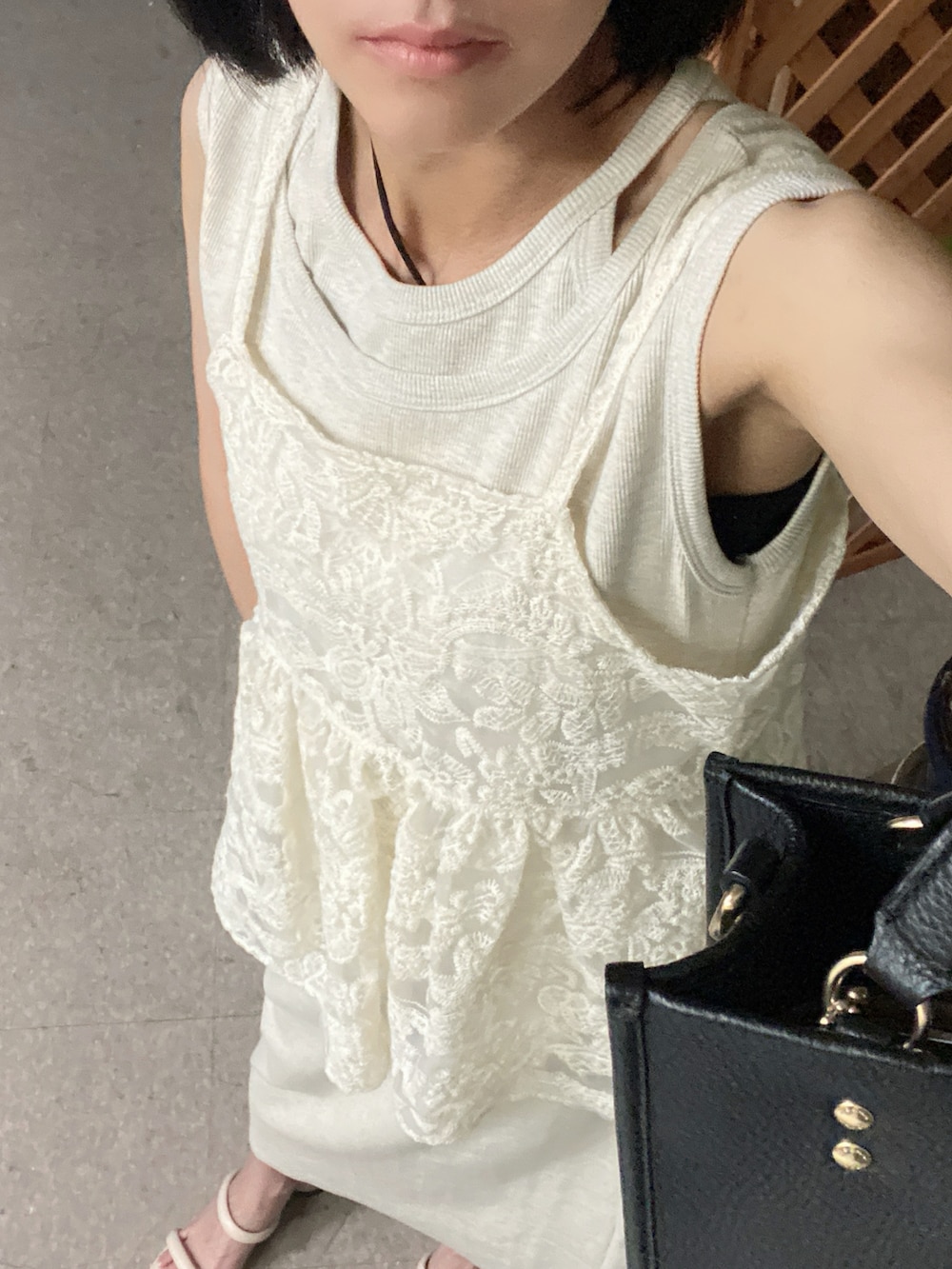 ホワイト系のキャミソール、ベージュ系のワンピース、ブラック系のイヤリングを着用したレディースの夏コーディネートの2枚目の写真