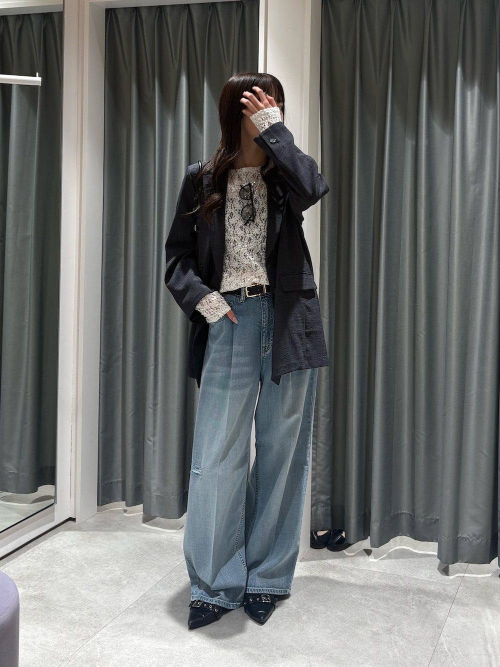 グレー系のテーラードジャケット、ホワイト系のTシャツ/カットソー、ブルー系のデニムパンツを着用したレディースの冬コーディネートの4枚目の写真