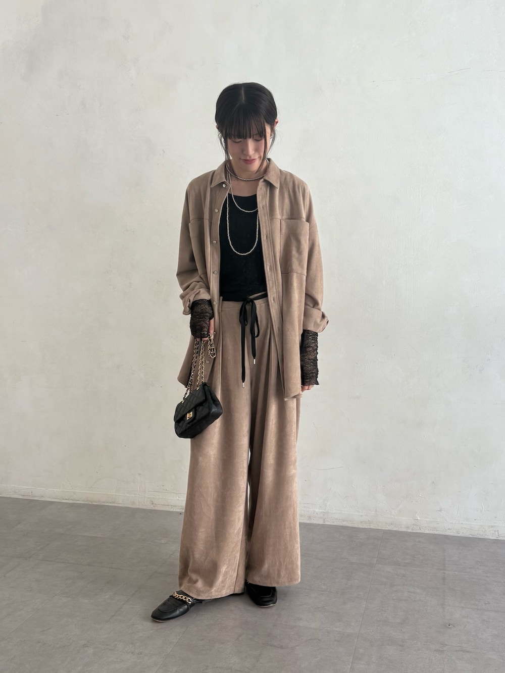 ベージュ系のシャツ/ブラウス、ベージュ系のその他パンツ、ブラック系のショルダーバッグを着用したレディースの夏コーディネートの2枚目の写真