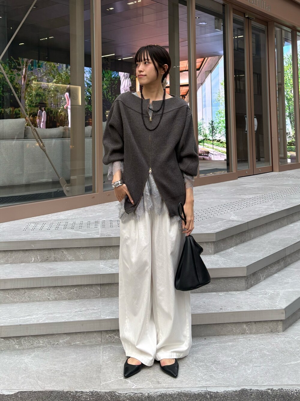 グレー系のニット/セーター、グレー系のTシャツ/カットソーを着用したレディースの冬コーディネートの4枚目の写真