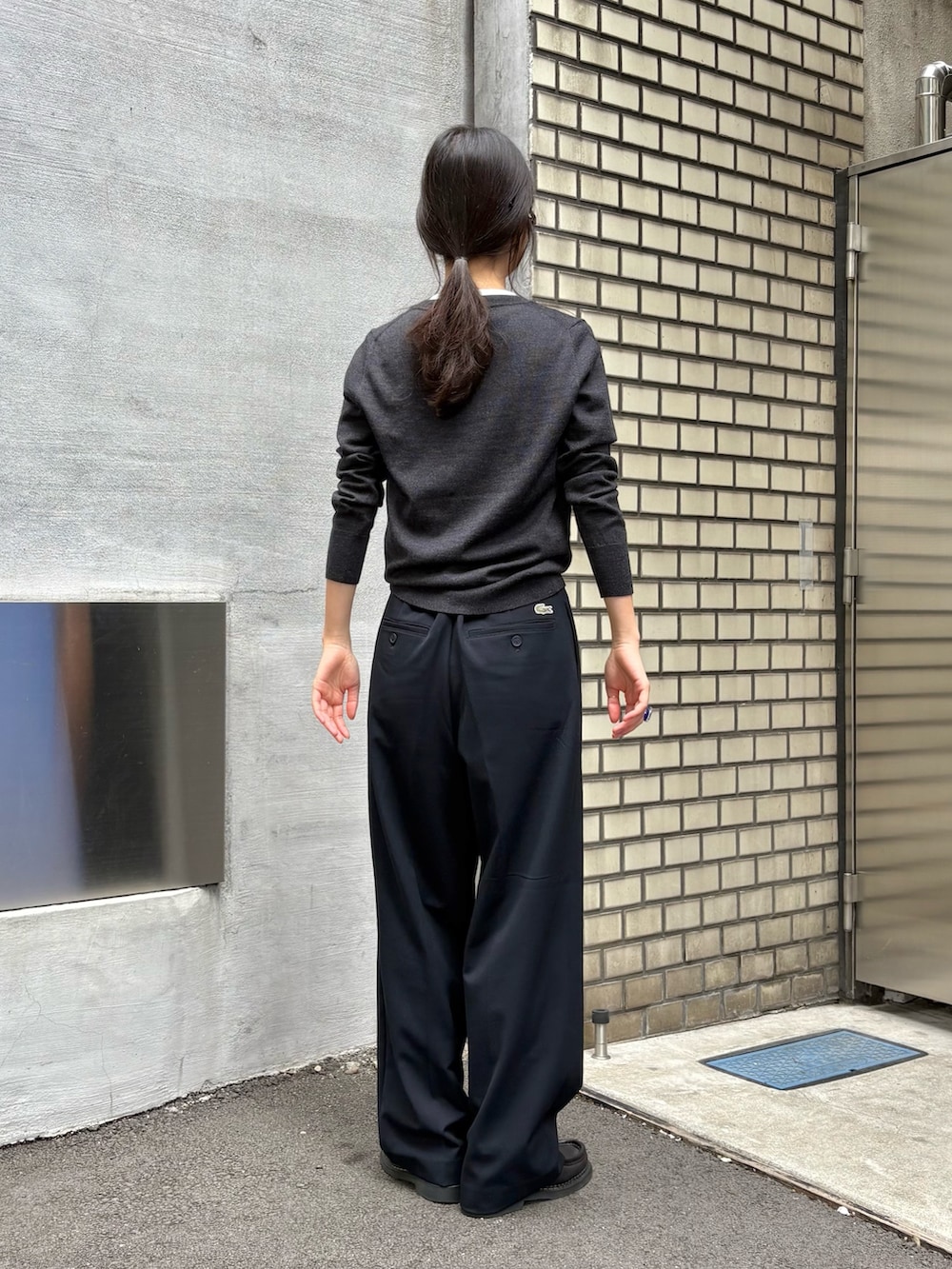 グレー系のカーディガン/ボレロ、ブルー系のスラックス、ブラック系のドレスシューズを着用したレディースの秋コーディネートの3枚目の写真