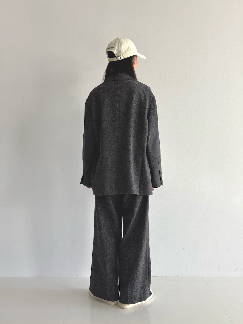 グレー系のテーラードジャケット、ホワイト系のTシャツ/カットソー、ブラウン系のスラックスを着用したレディースの秋コーディネートの3枚目の写真