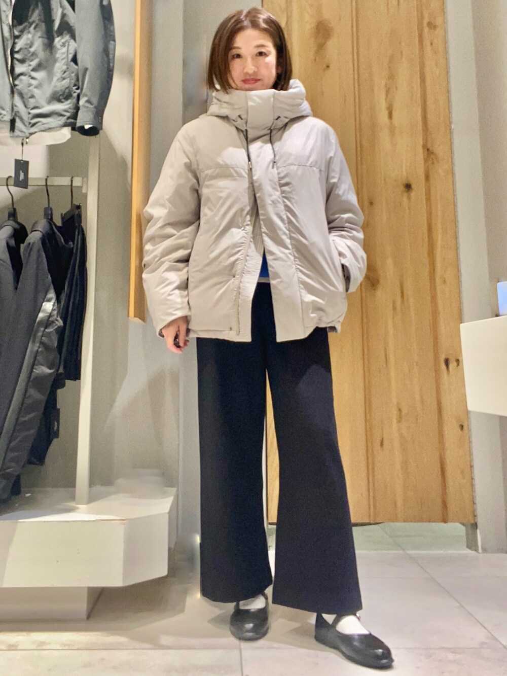 ベージュ系のダウンジャケット/コート、ブルー系のニット/セーターを着用したレディースの冬コーディネートの2枚目の写真