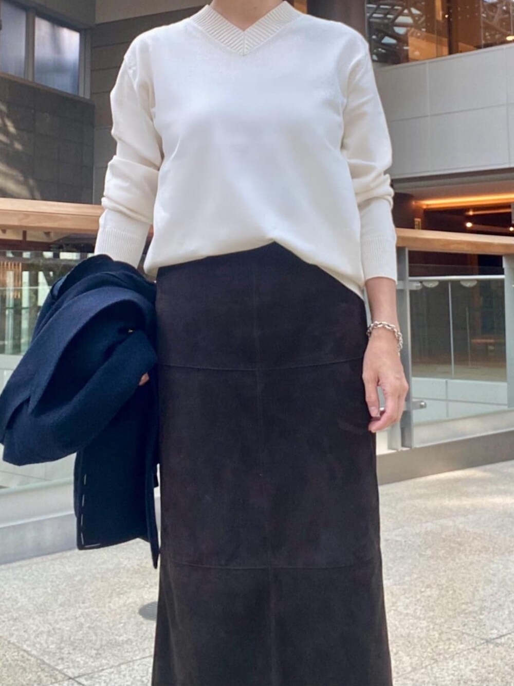 ホワイト系のニット/セーターを着用したレディースの冬コーディネートの2枚目の写真