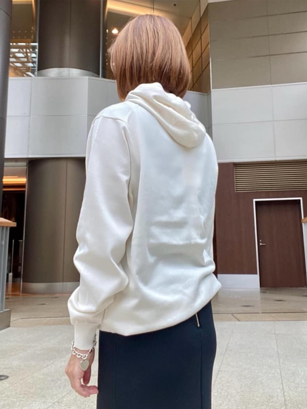 ホワイト系のパーカーを着用したレディースの冬コーディネートの4枚目の写真