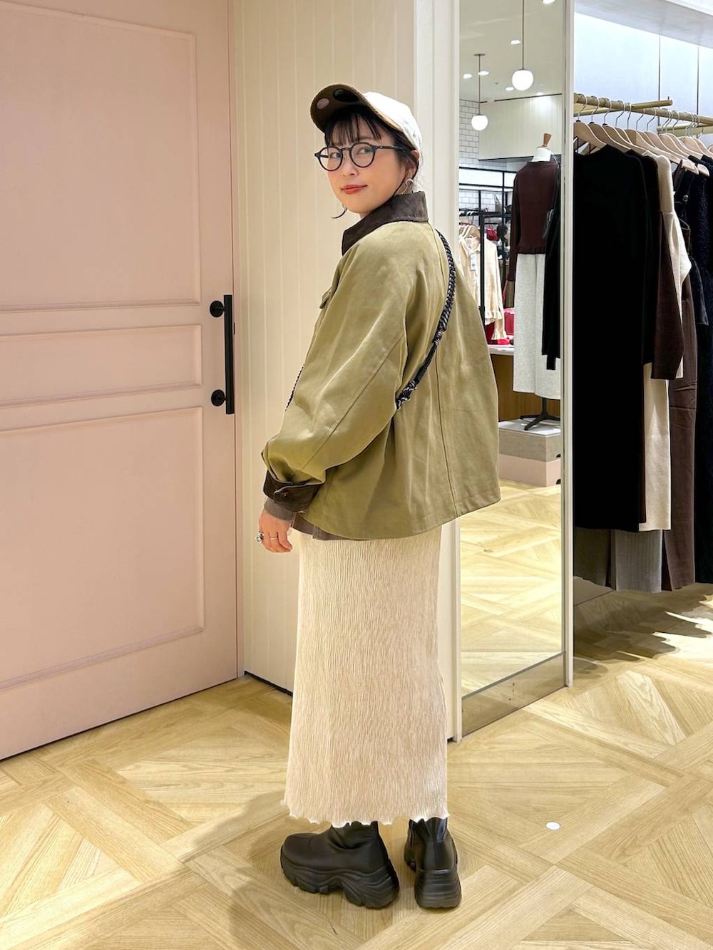 ブラック系のブーツ、ブラウン系のスウェット、ブラウン系のその他アウターを着用したレディースの秋コーディネートの5枚目の写真