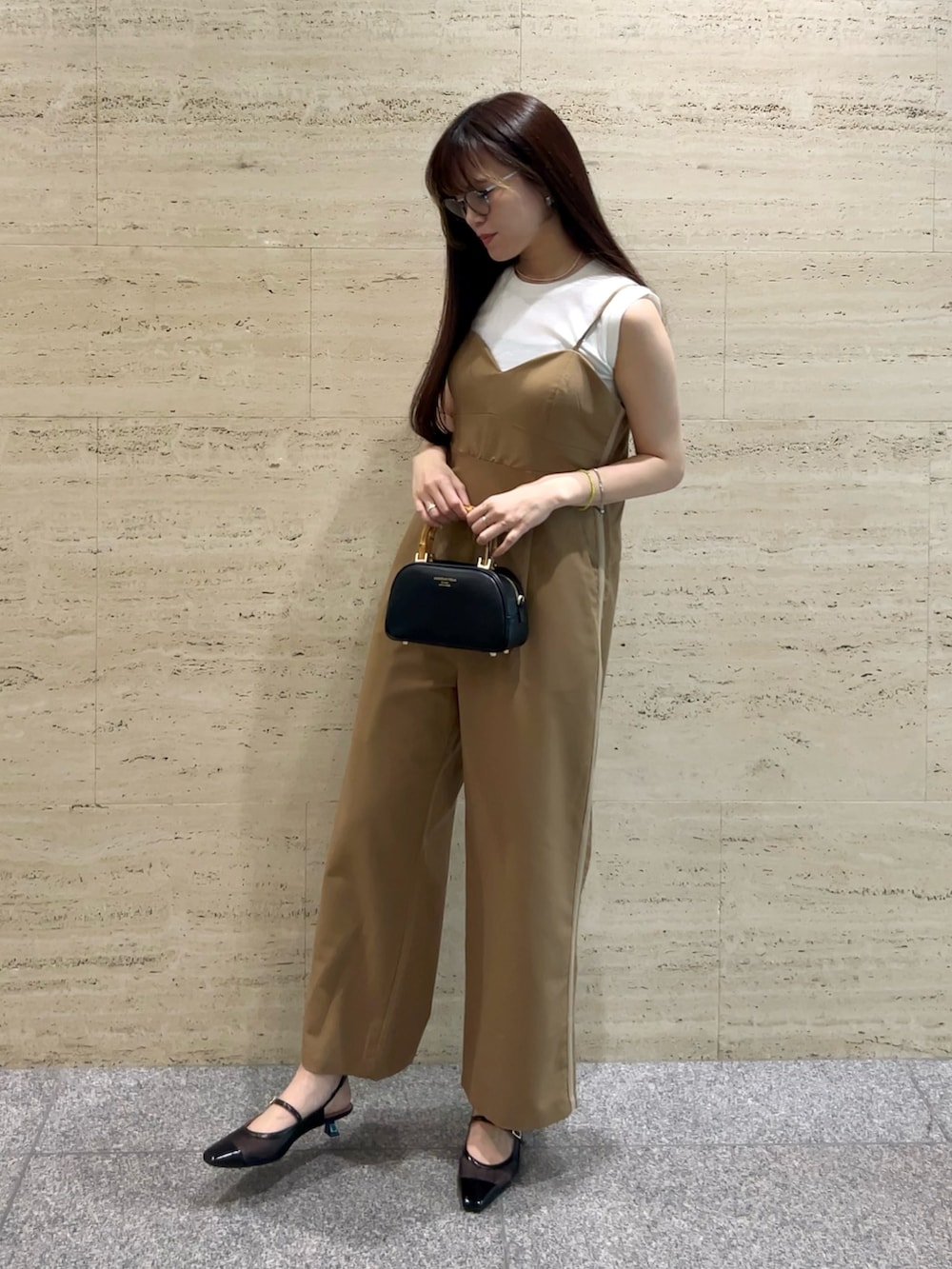 ベージュ系のサロペット/オーバーオール、ホワイト系のハンドバッグ、ブラック系のパンプスを着用したレディースの夏コーディネートの2枚目の写真