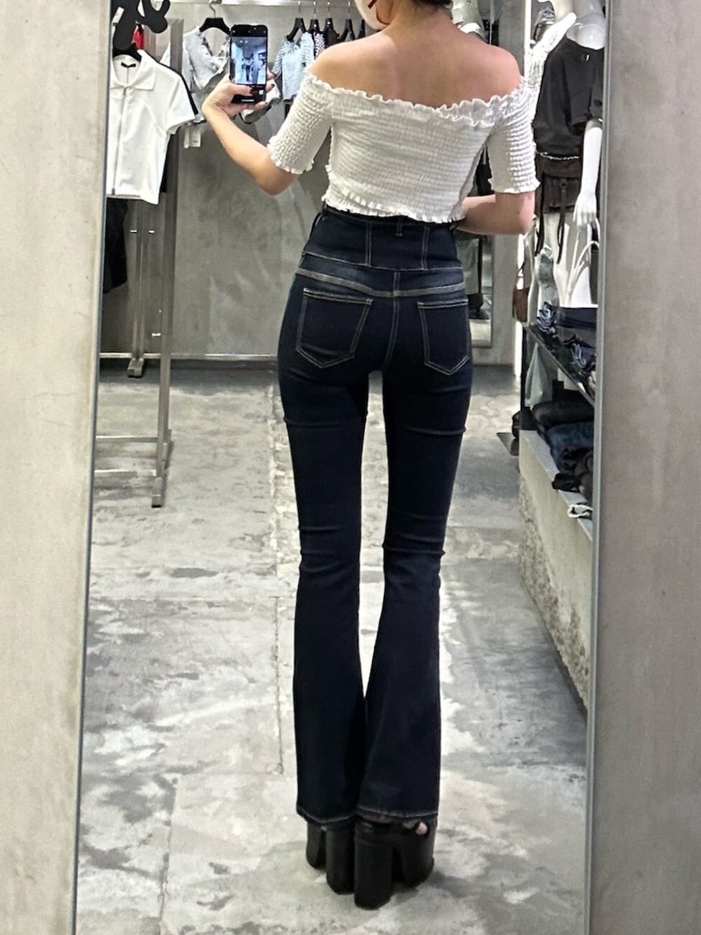 ブラック系のサンダル、ホワイト系のTシャツ/カットソー、ブルー系のデニムパンツを着用したレディースの夏コーディネートの3枚目の写真